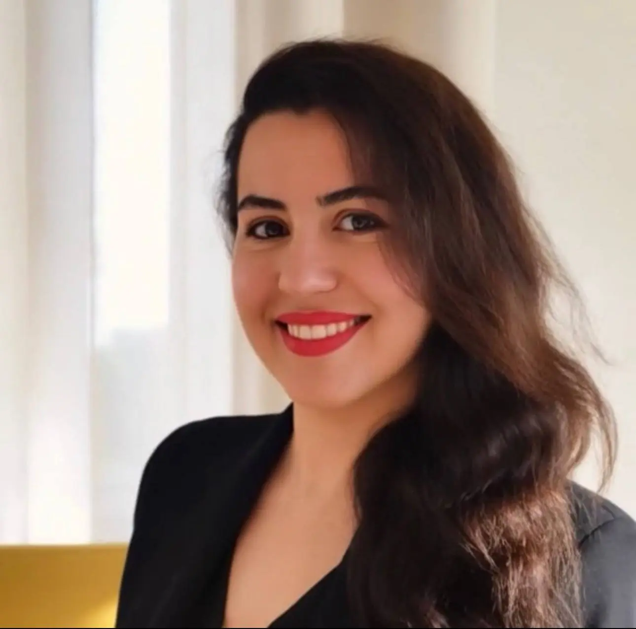 Fah Karimi, founder and creative director of Atelier Romance, seated at her desk