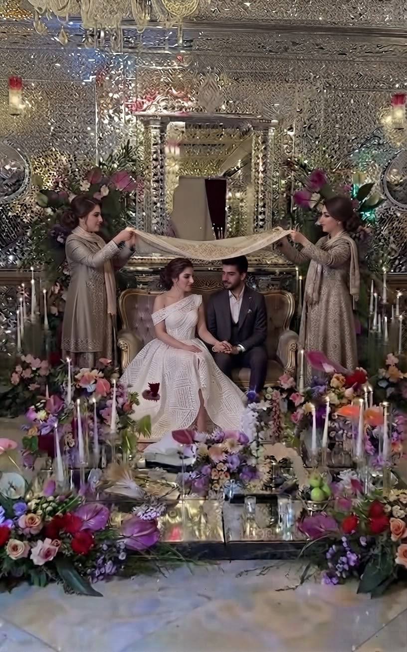 Persian wedding Sofreh Aghd ceremony with the couple seated beneath a decorative canopy